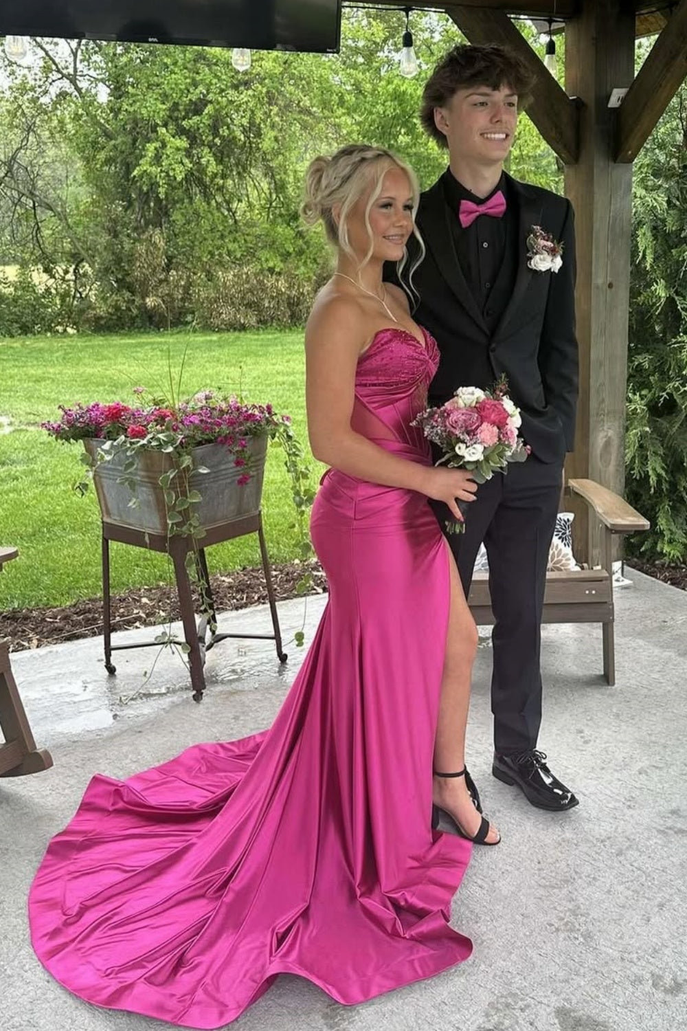 Pink satin mermaid prom dress with beading, side slit, and long train.