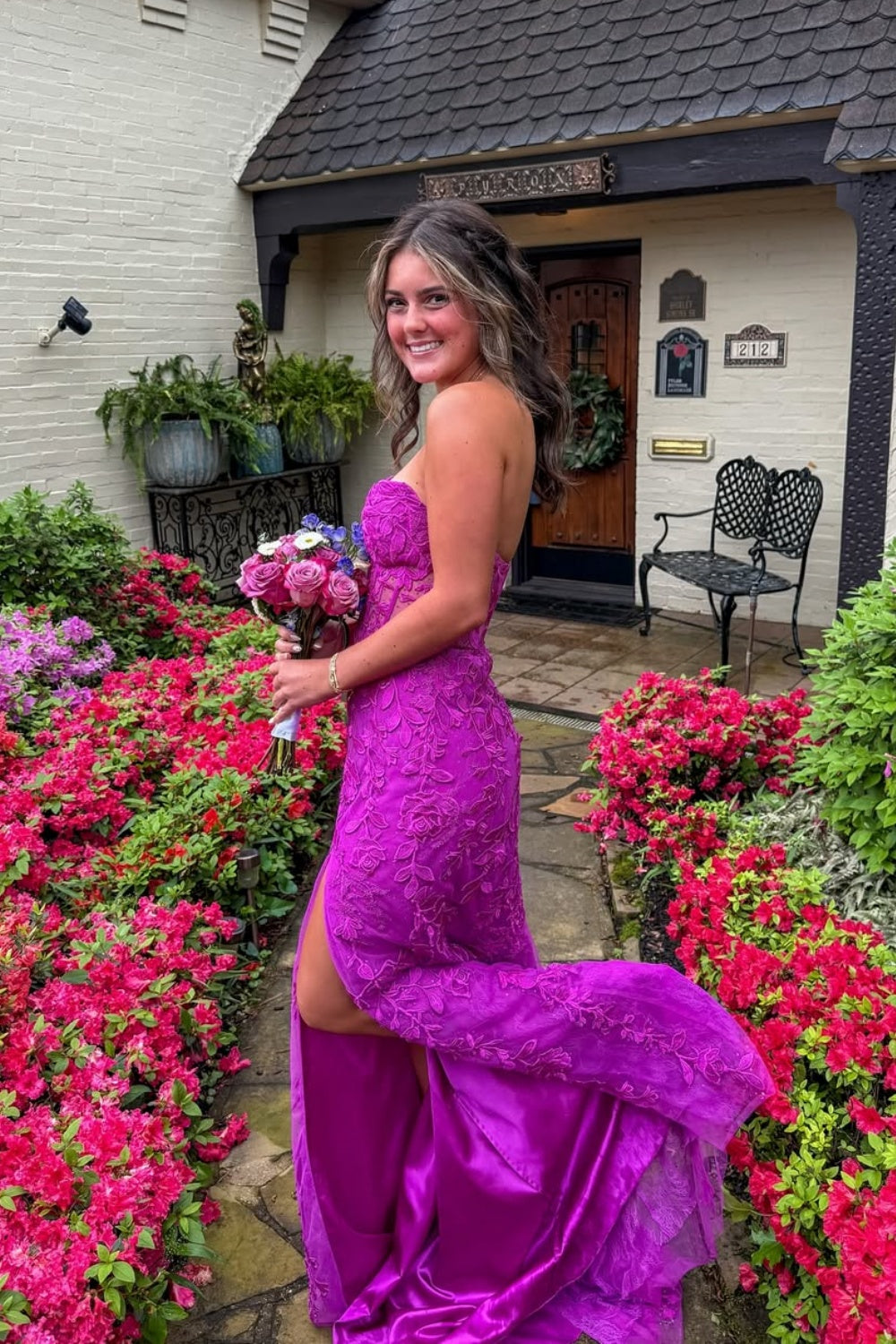 Purple mermaid prom dress with lace appliques, illusion bodice, and high slit.