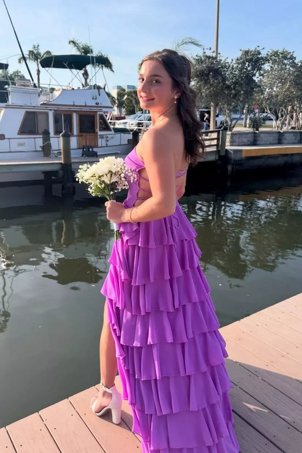 Strapless purple A-line chiffon prom dress with tiered skirt and side slit.