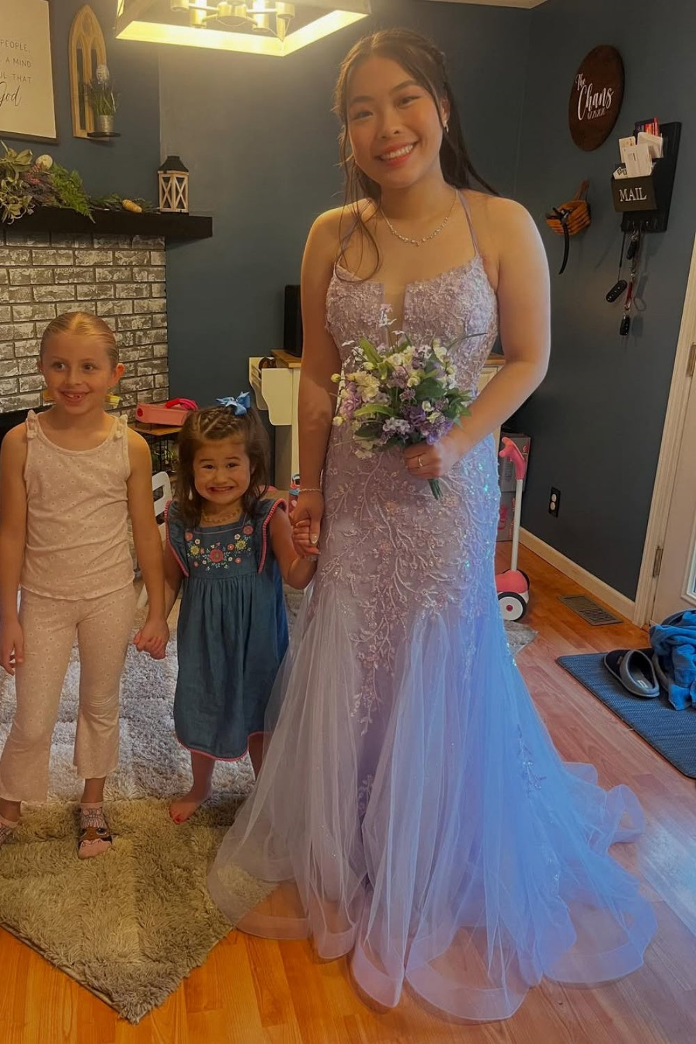 Lavender tulle A-line prom dress with lace appliques and spaghetti straps.