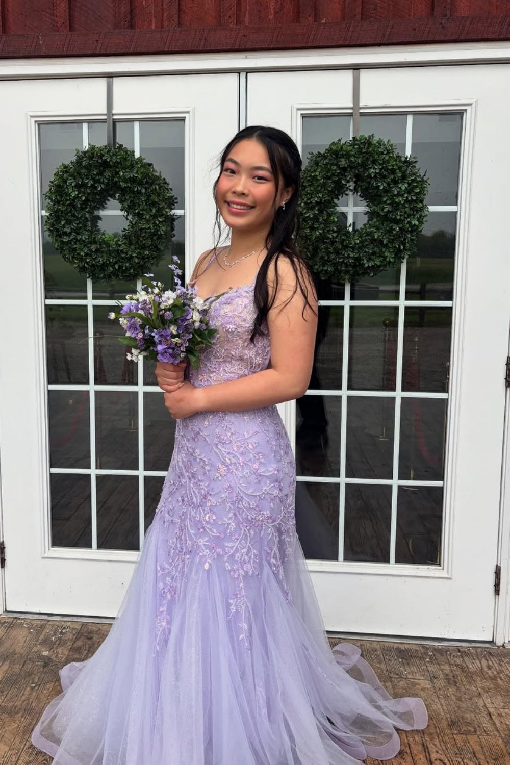 Lavender tulle A-line prom dress with lace appliques and spaghetti straps.