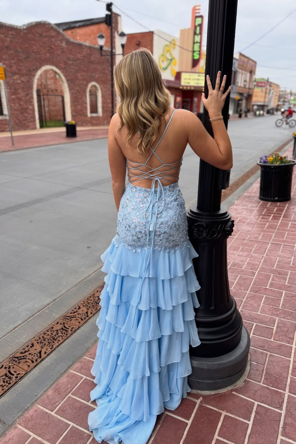 Light blue A-line chiffon prom dress featuring lace appliques and tiered ruffle skirt.