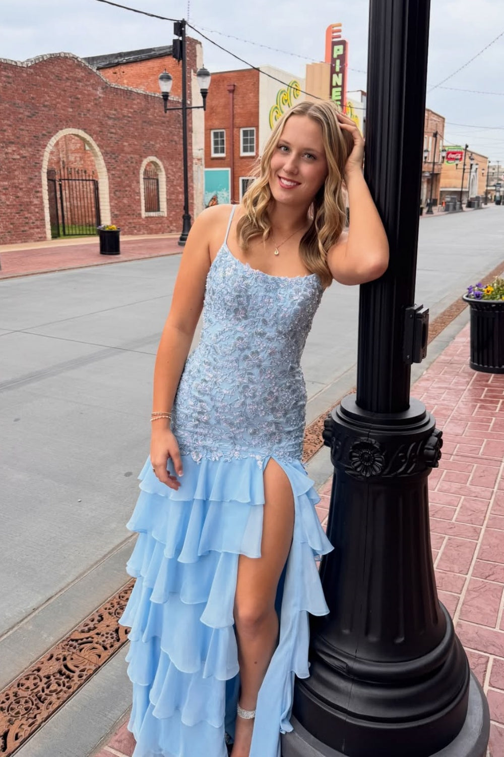 Light blue A-line chiffon prom dress featuring lace appliques and tiered ruffle skirt.