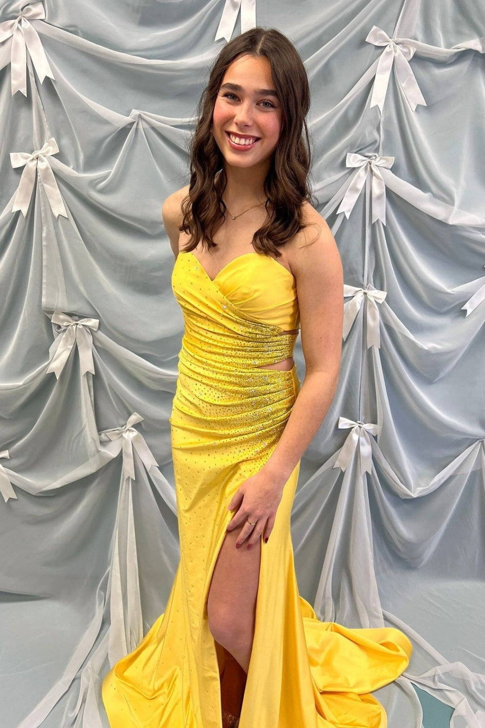 Sweetheart neckline yellow mermaid prom dress with intricate beading and side cut-out details.