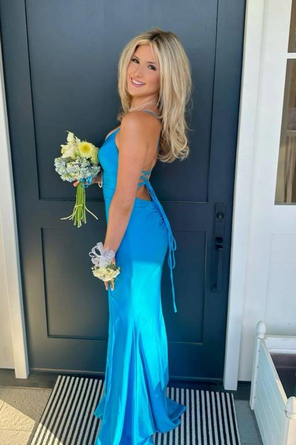 Bright blue V-neck mermaid prom dress with thin straps, side slit, and hidden pockets.