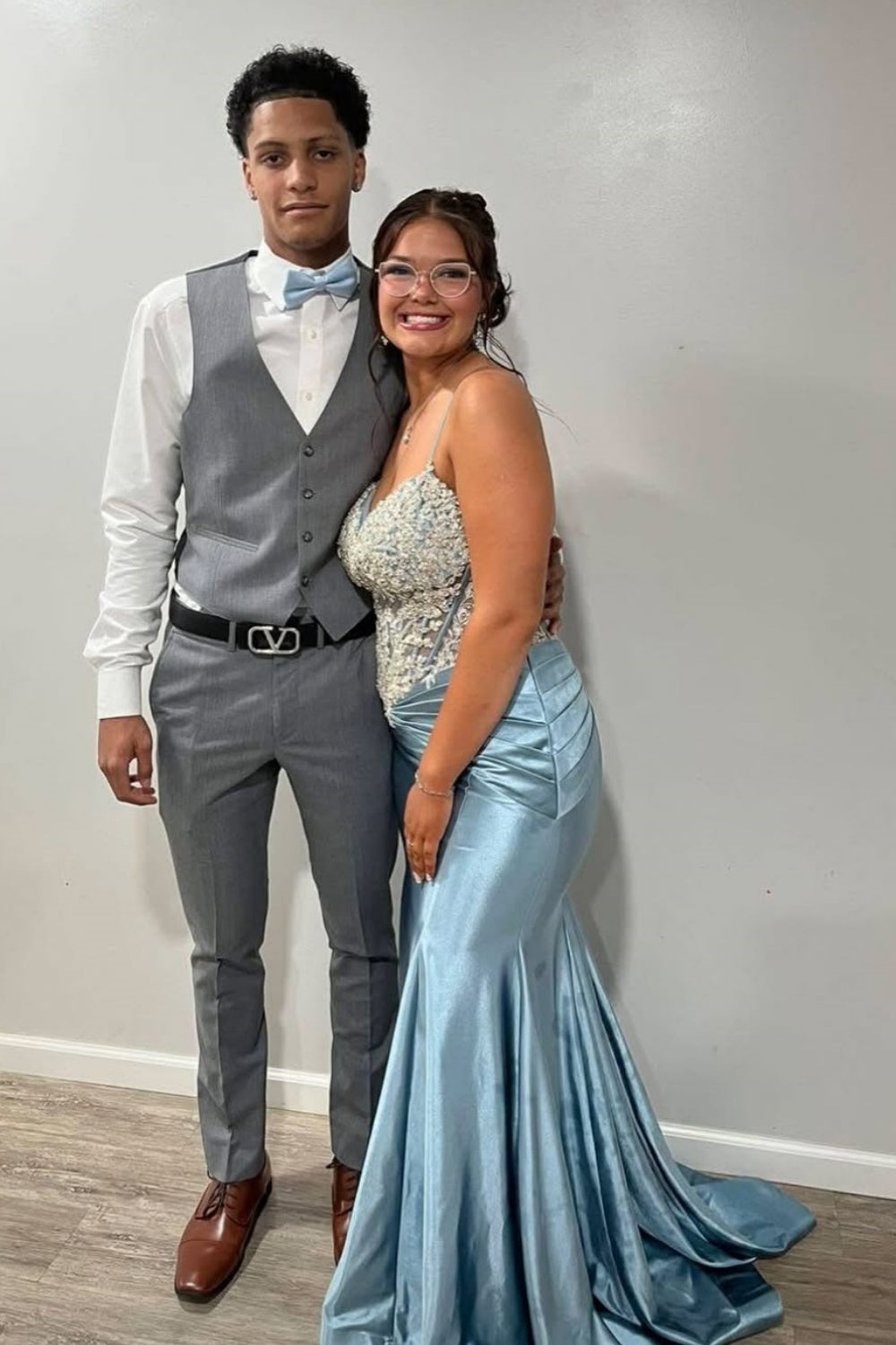 Light blue beaded mermaid evening gown with spaghetti straps.