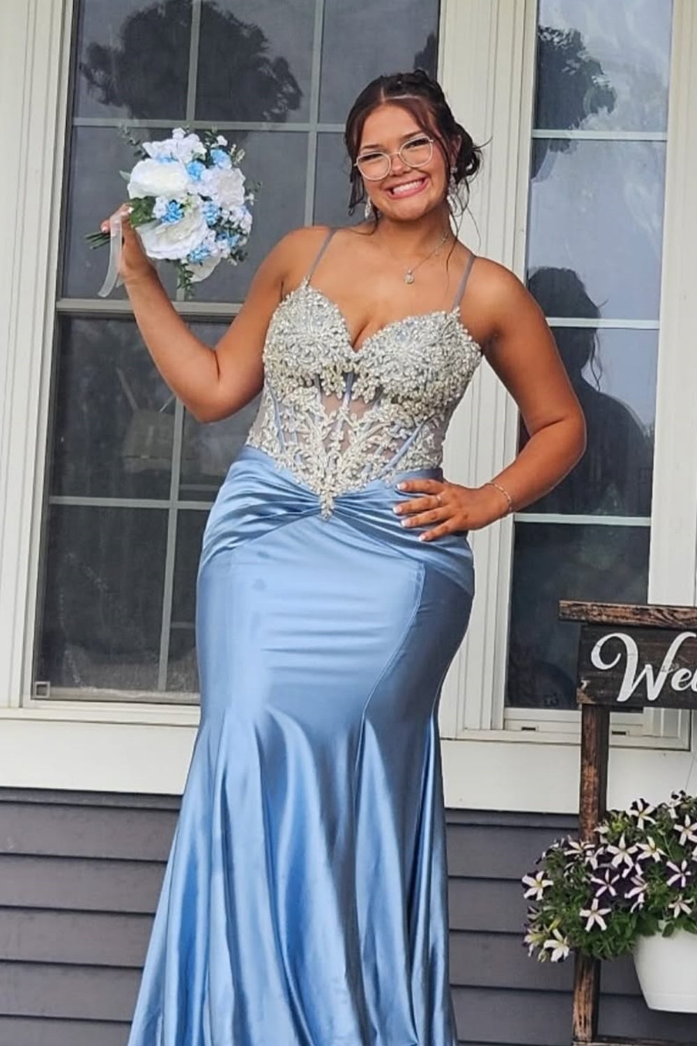 Light blue beaded mermaid evening gown with spaghetti straps.