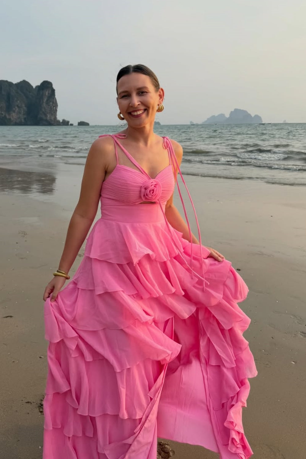 Pink ruffle A-line chiffon prom dress with bow shoulder straps.