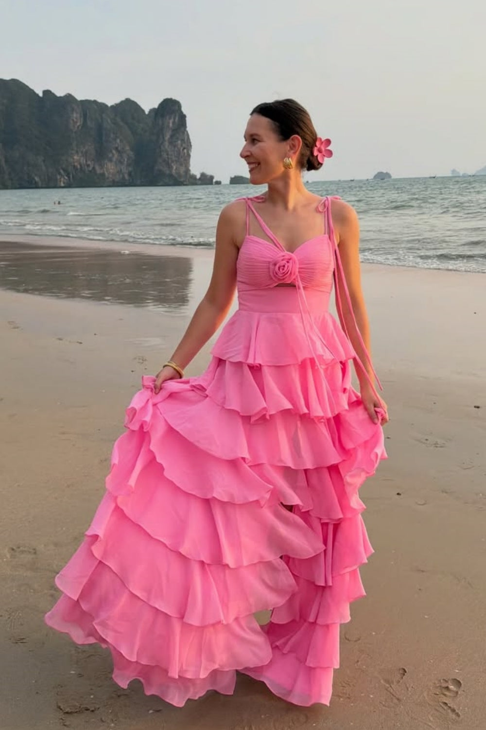Pink ruffle A-line chiffon prom dress with bow shoulder straps.