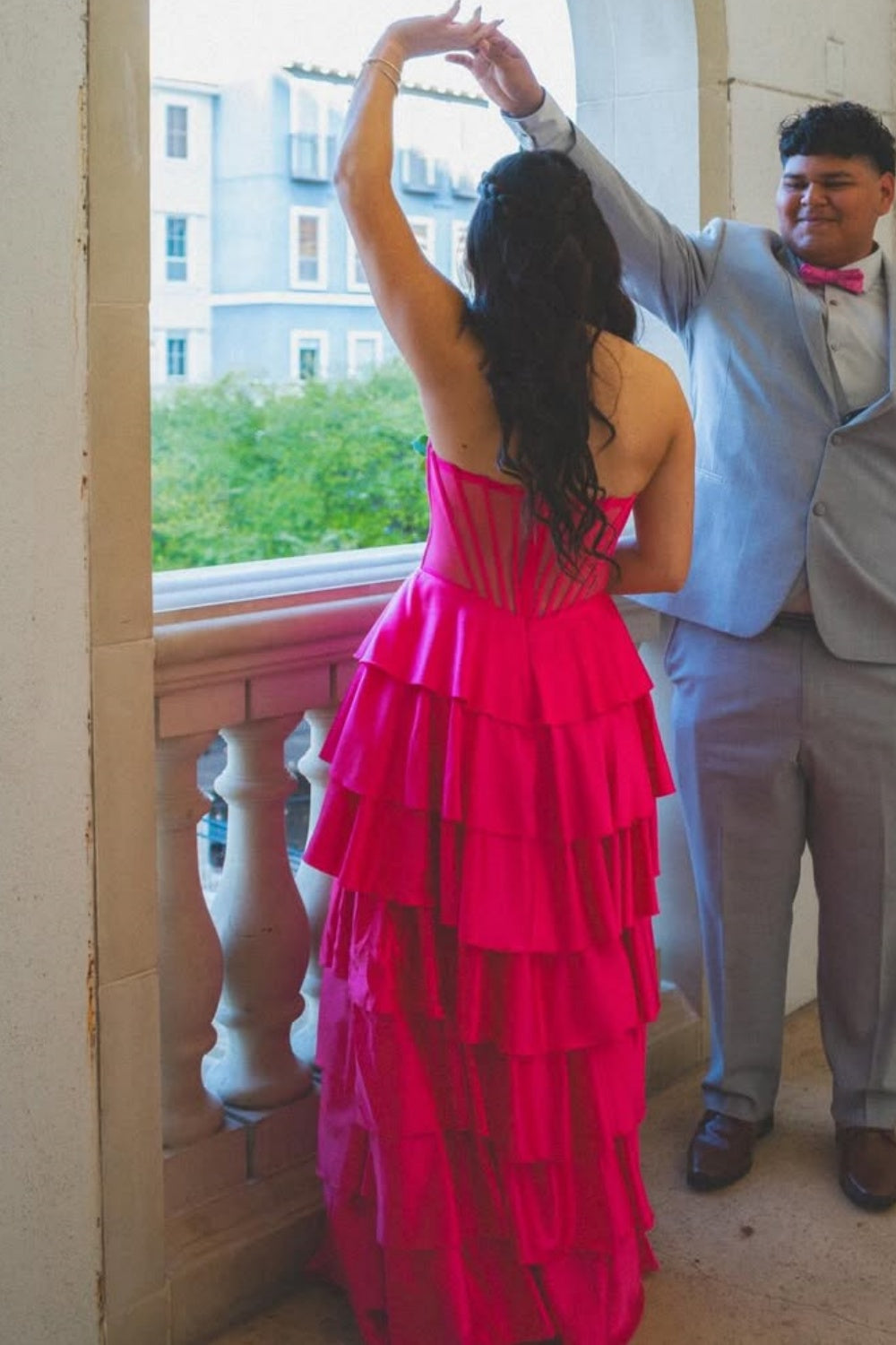 Fuchsia strapless ruffle A-line prom dress with illusion corset.