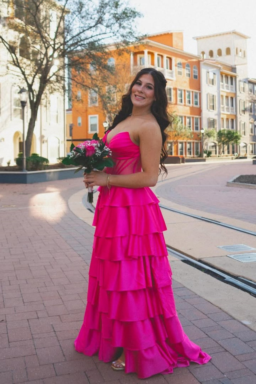 Fuchsia strapless ruffle A-line prom dress with illusion corset.