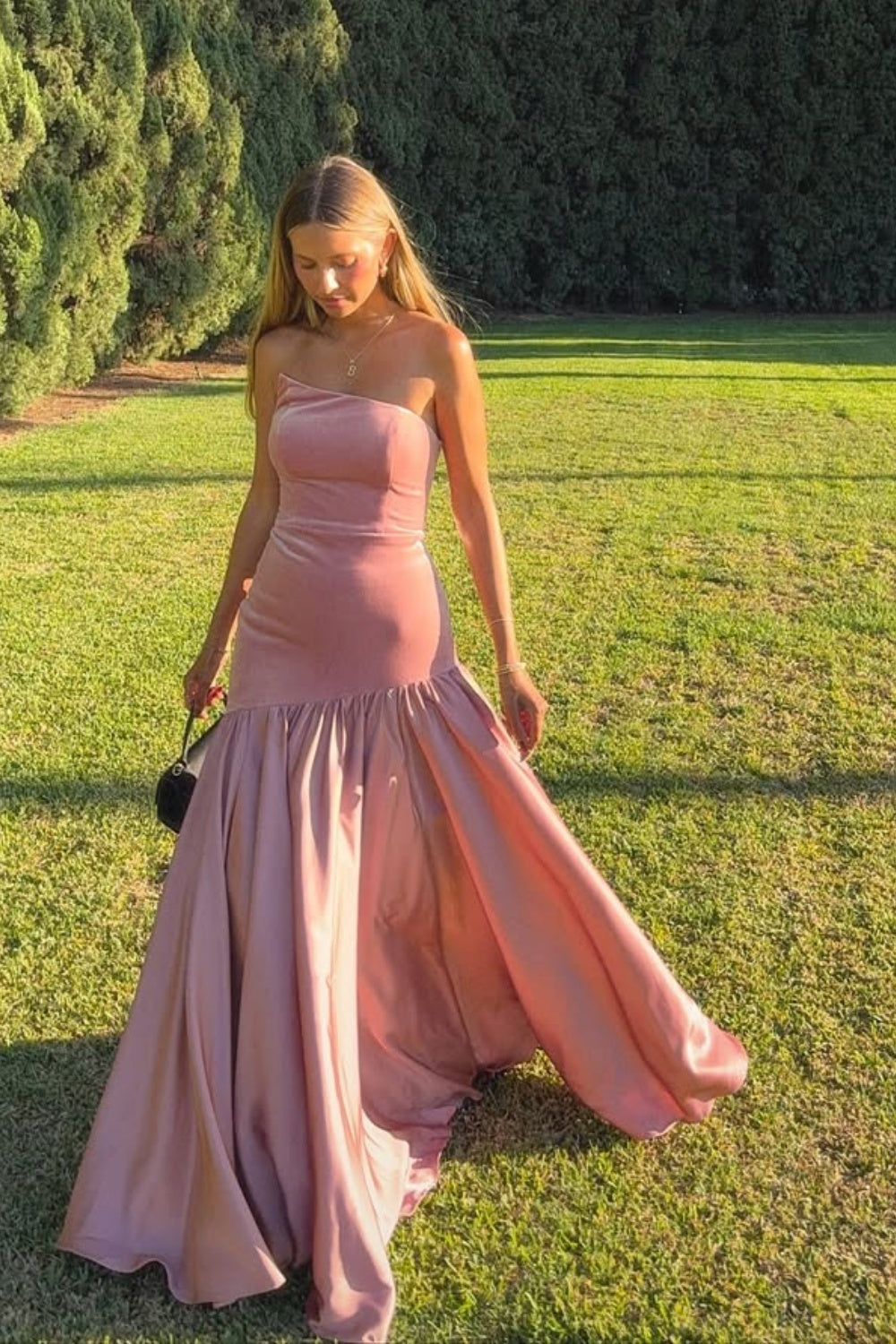 Pink A-line long prom dress with ruched bodice and irregular neckline.