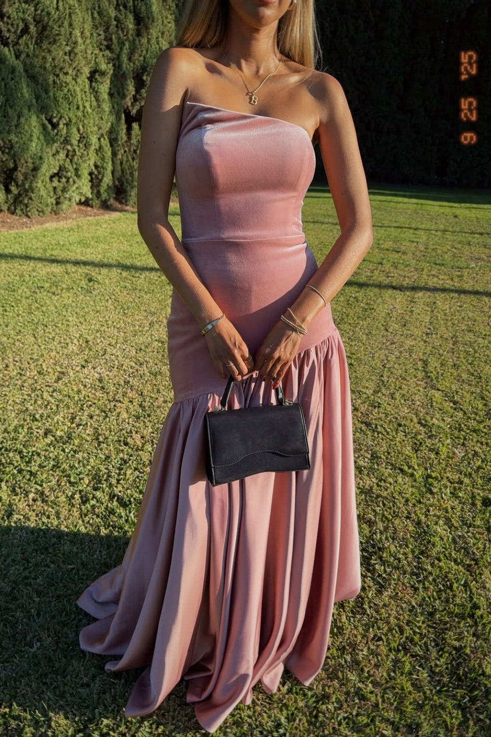 Pink A-line long prom dress with ruched bodice and irregular neckline.