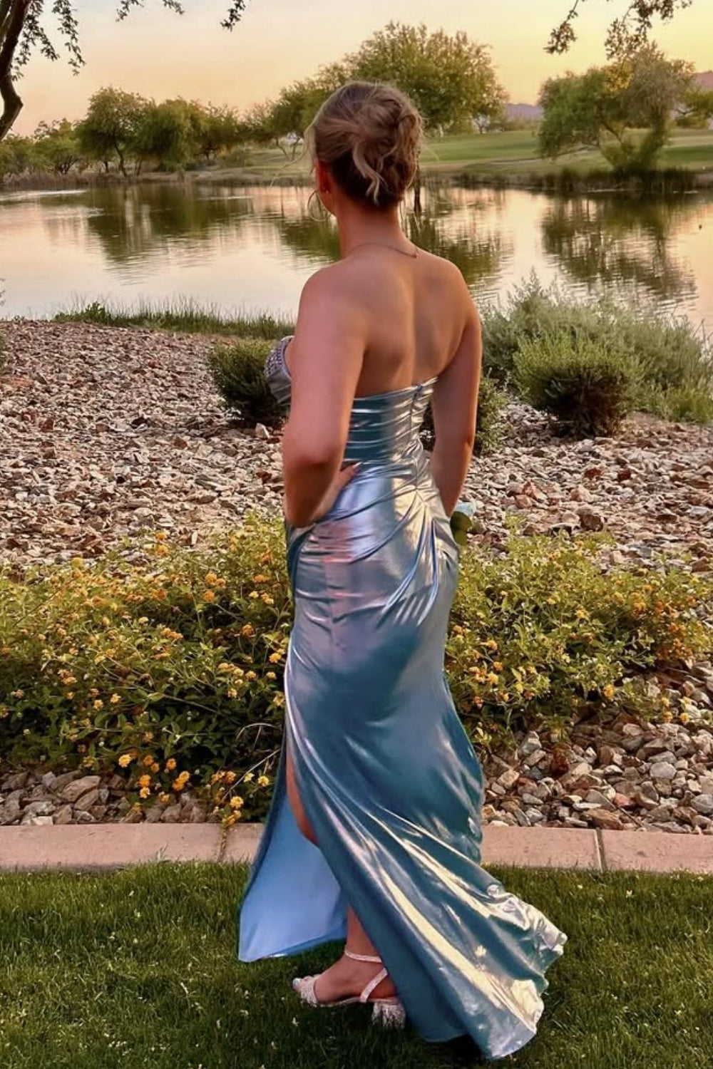 Light blue sweetheart formal dress with beaded ruched detail and leg slit.