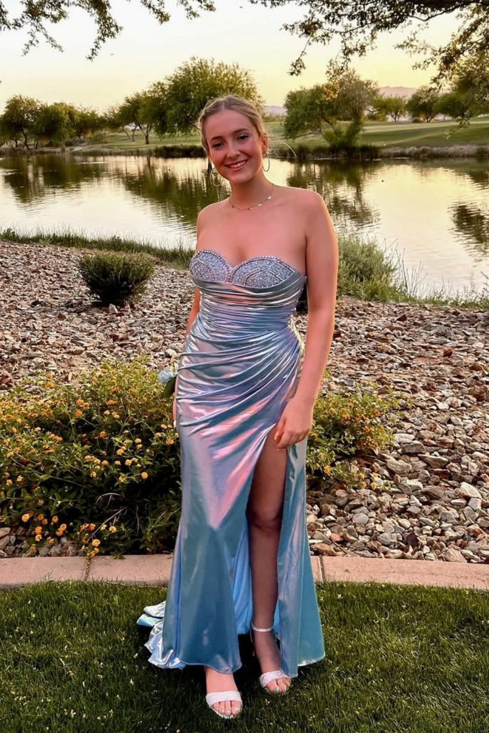 Light blue sweetheart formal dress with beaded ruched detail and leg slit.