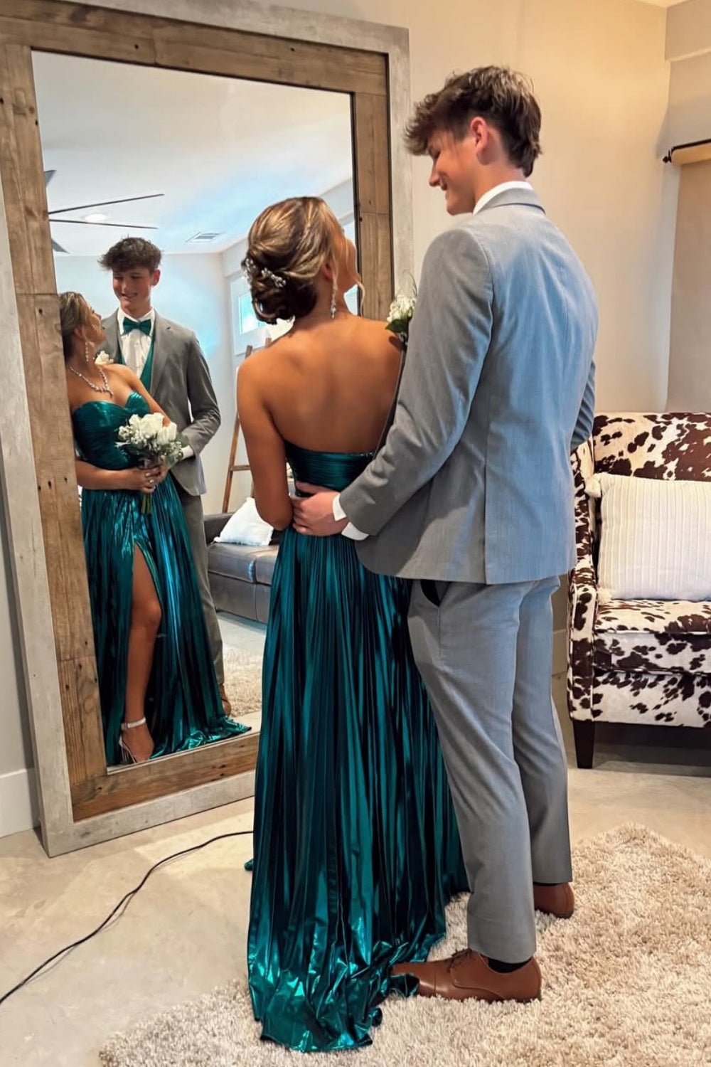 Metallic green strapless pleated A-line prom dress with twist keyhole detail.
