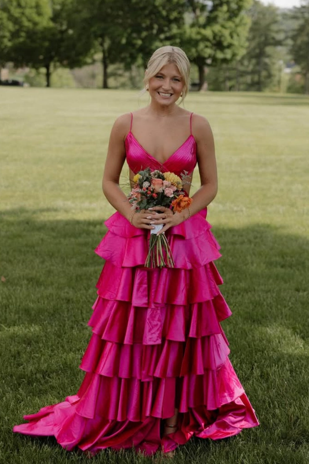 Fuchsia A-line ruffle prom dress with spaghetti straps and criss-cross back.