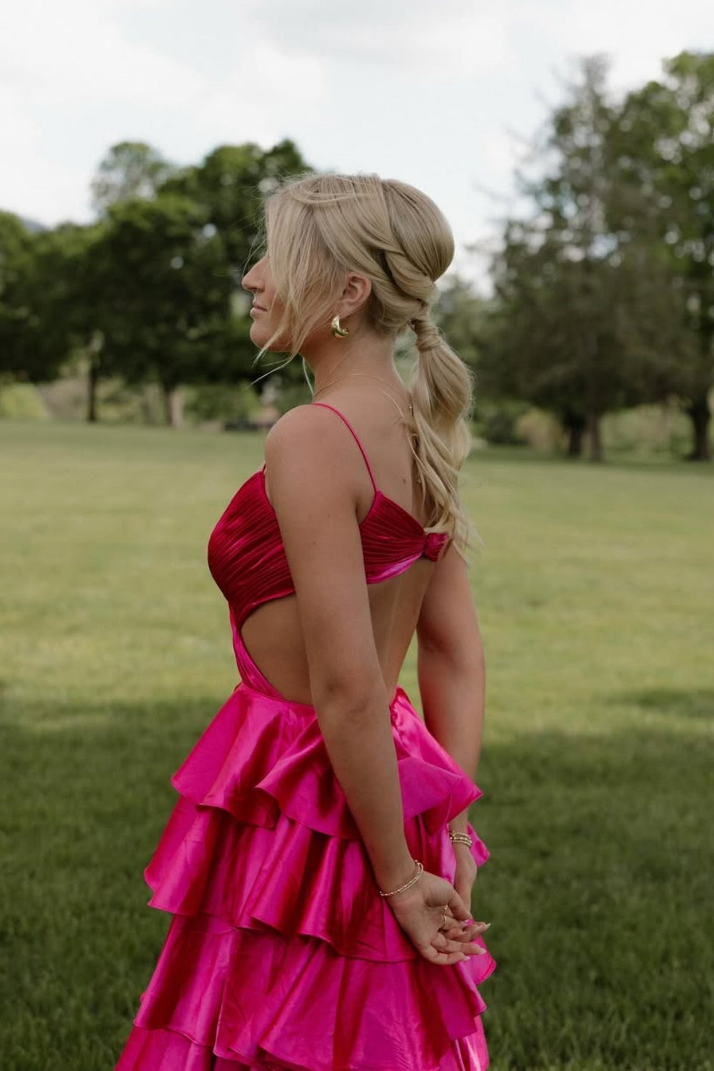 Fuchsia A-line ruffle prom dress with spaghetti straps and criss-cross back.