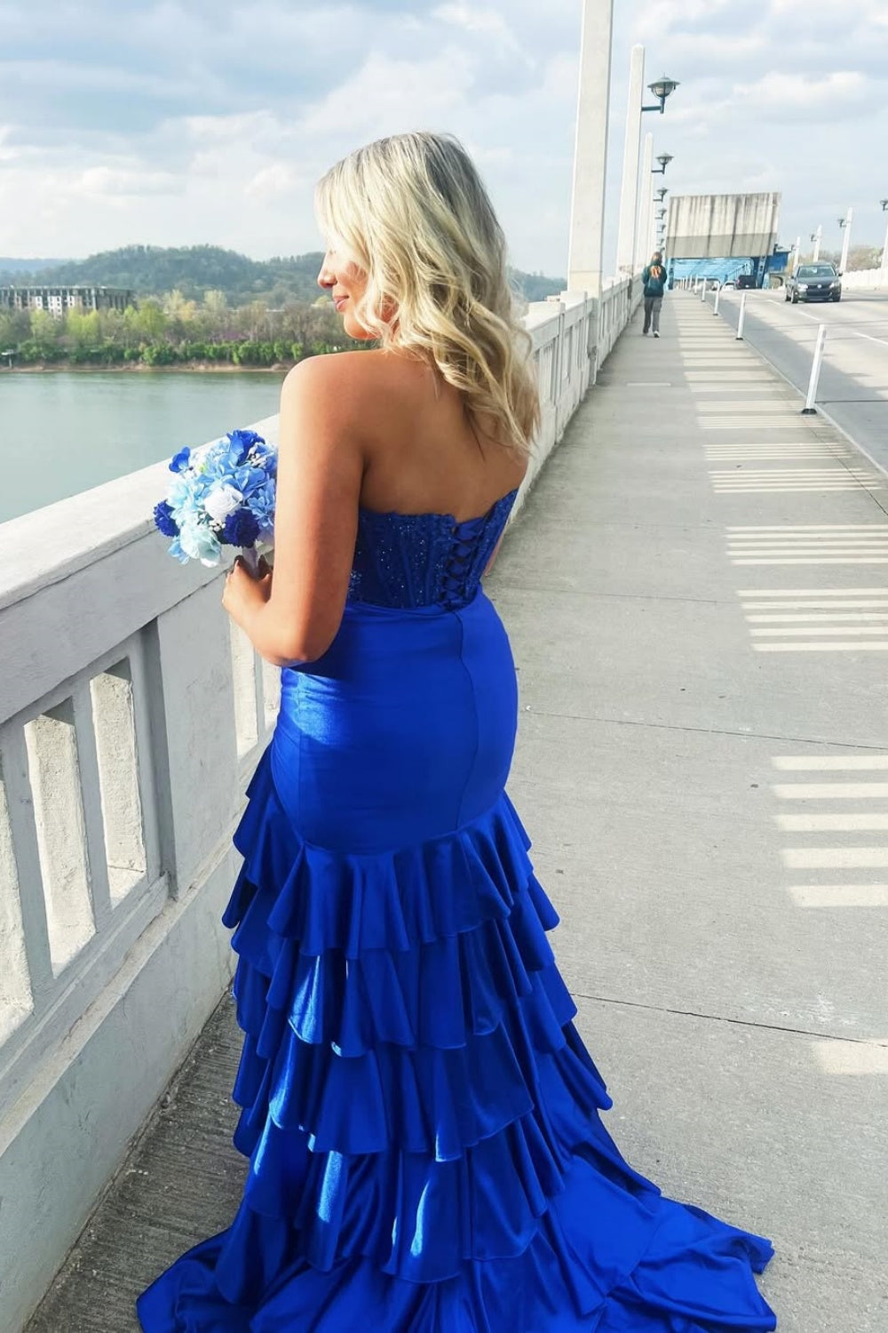 Royal blue strapless beaded A-line formal dress with ruched bodice and ruffle slit.