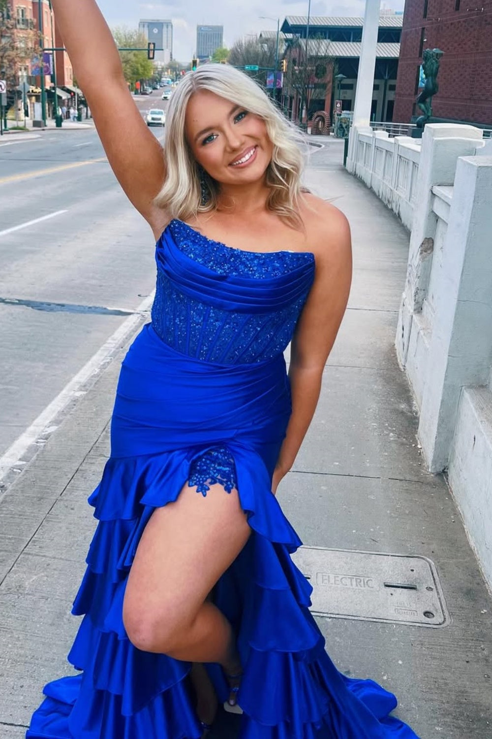 Royal blue strapless beaded A-line formal dress with ruched bodice and ruffle slit.