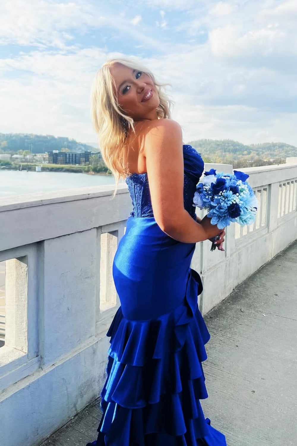 Royal blue strapless beaded A-line formal dress with ruched bodice and ruffle slit.