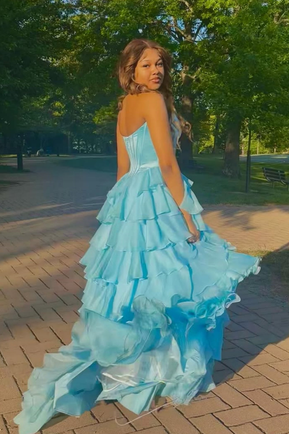 sweetheart corset A-line tiered gown with lace appliques and side slit.