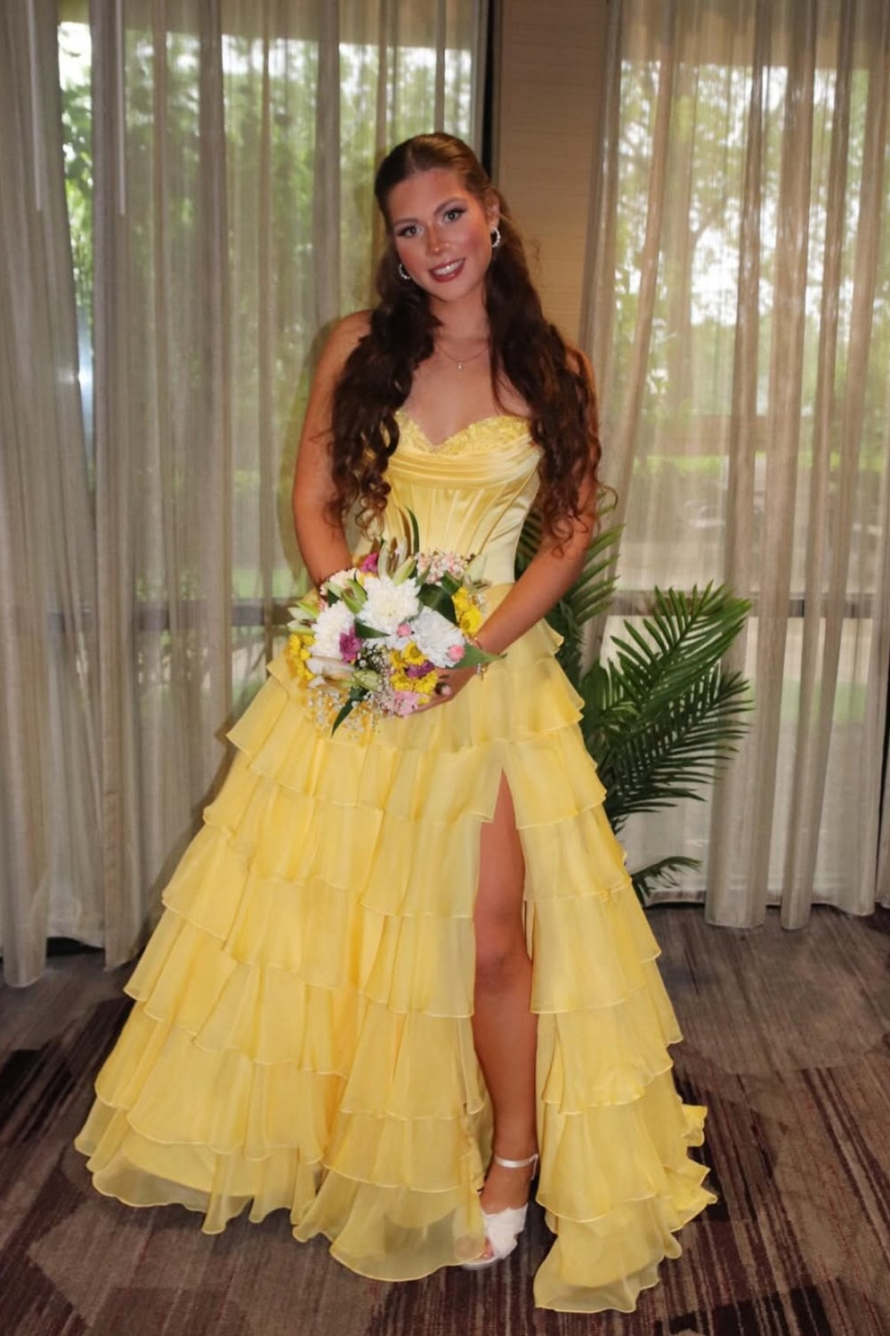 sweetheart corset A-line tiered gown with lace appliques and side slit.