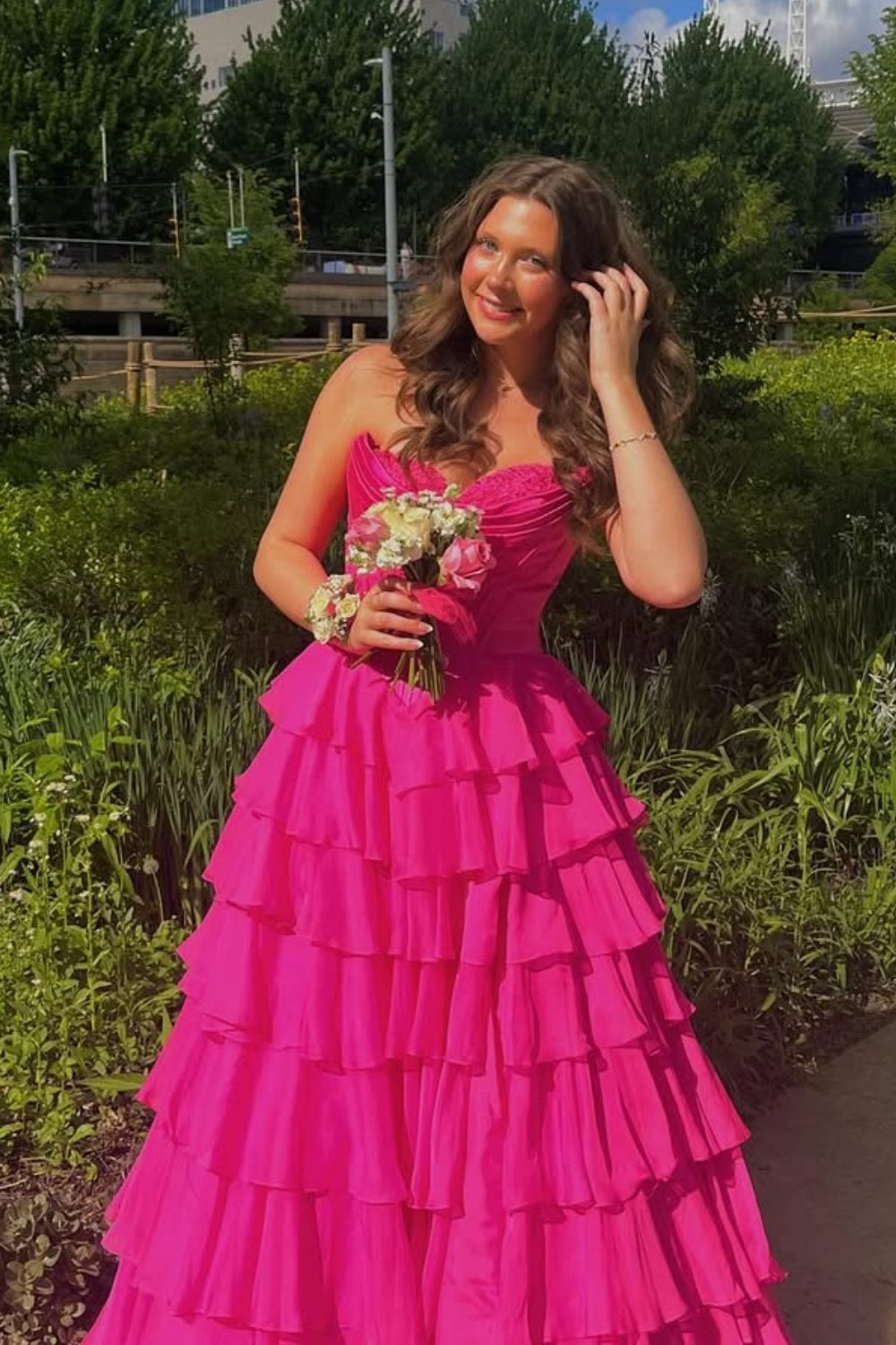 sweetheart corset A-line tiered gown with lace appliques and side slit.