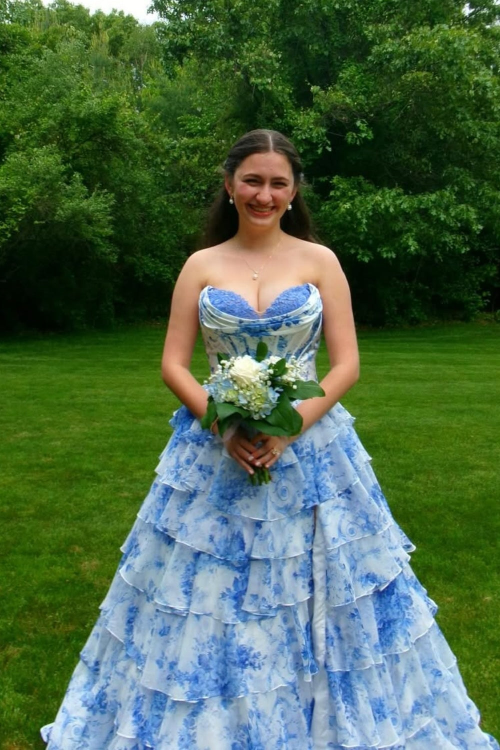 sweetheart corset A-line tiered gown with lace appliques and side slit.