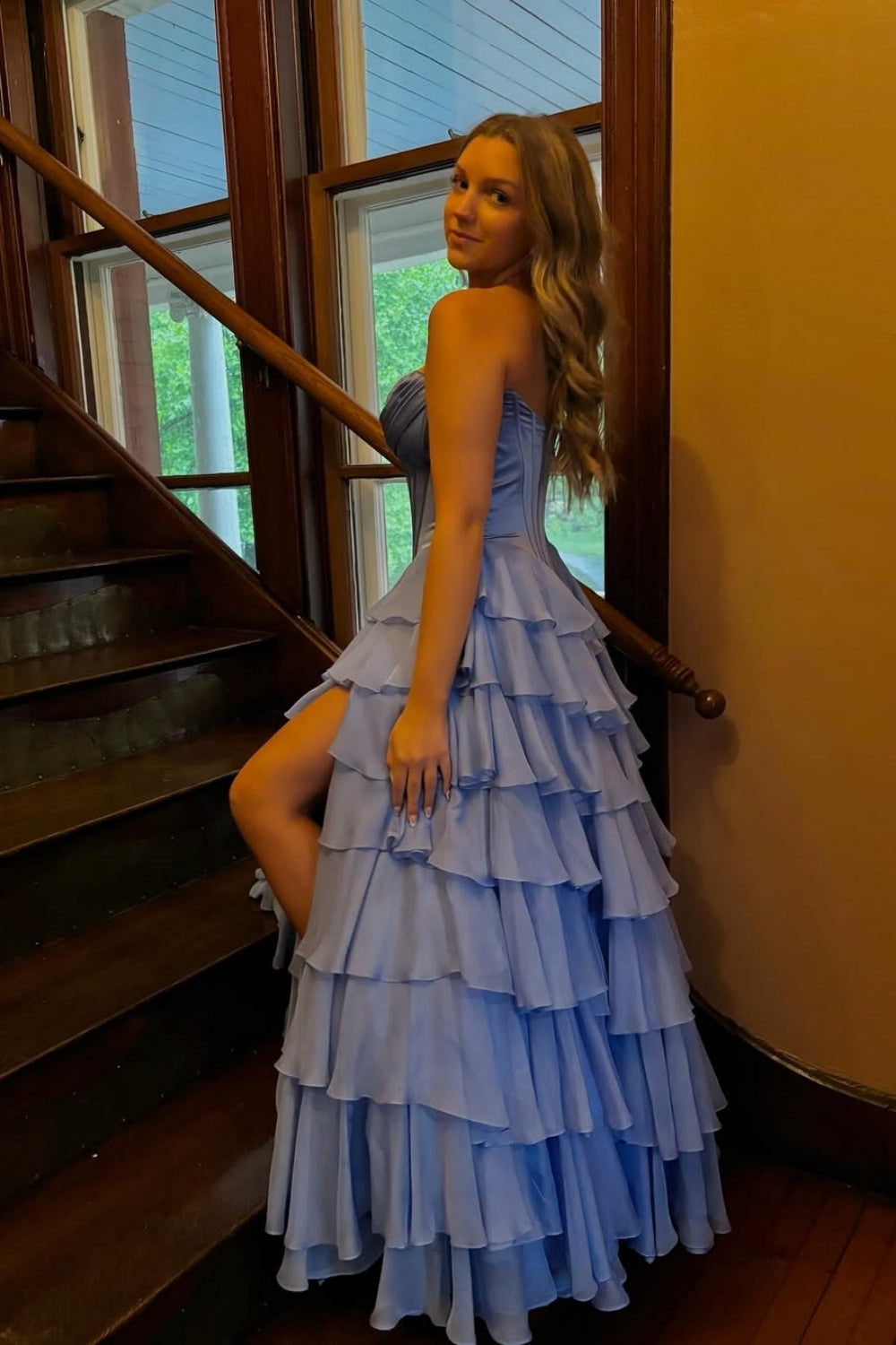 sweetheart corset A-line tiered gown with lace appliques and side slit.