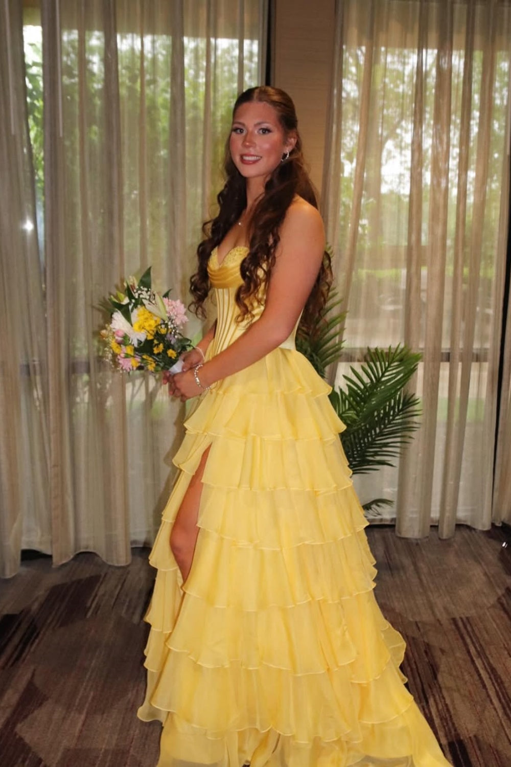 sweetheart corset A-line tiered gown with lace appliques and side slit.