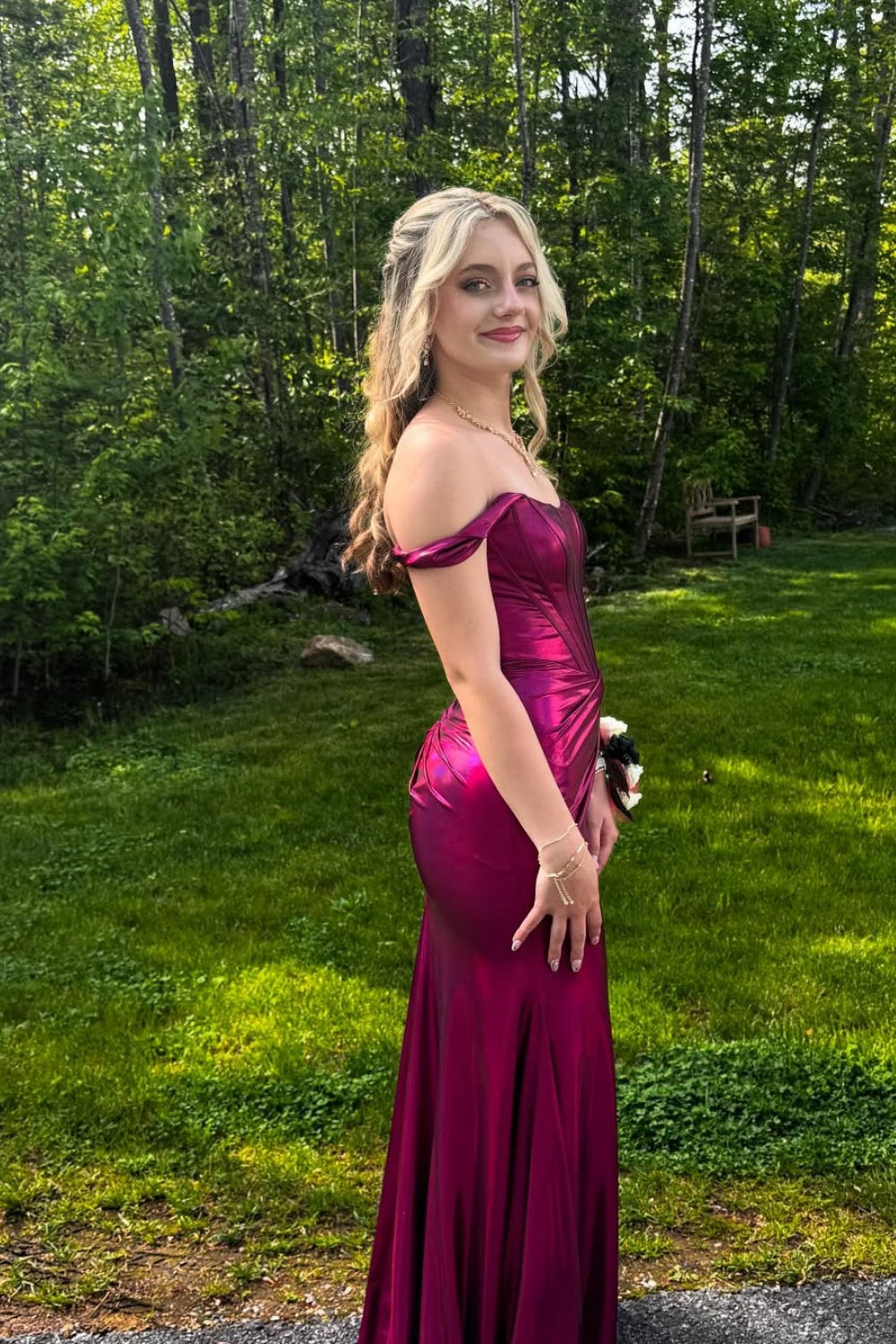 Metallic fuchsia off-the-shoulder mermaid prom dress with a structured corset bodice and high leg slit.