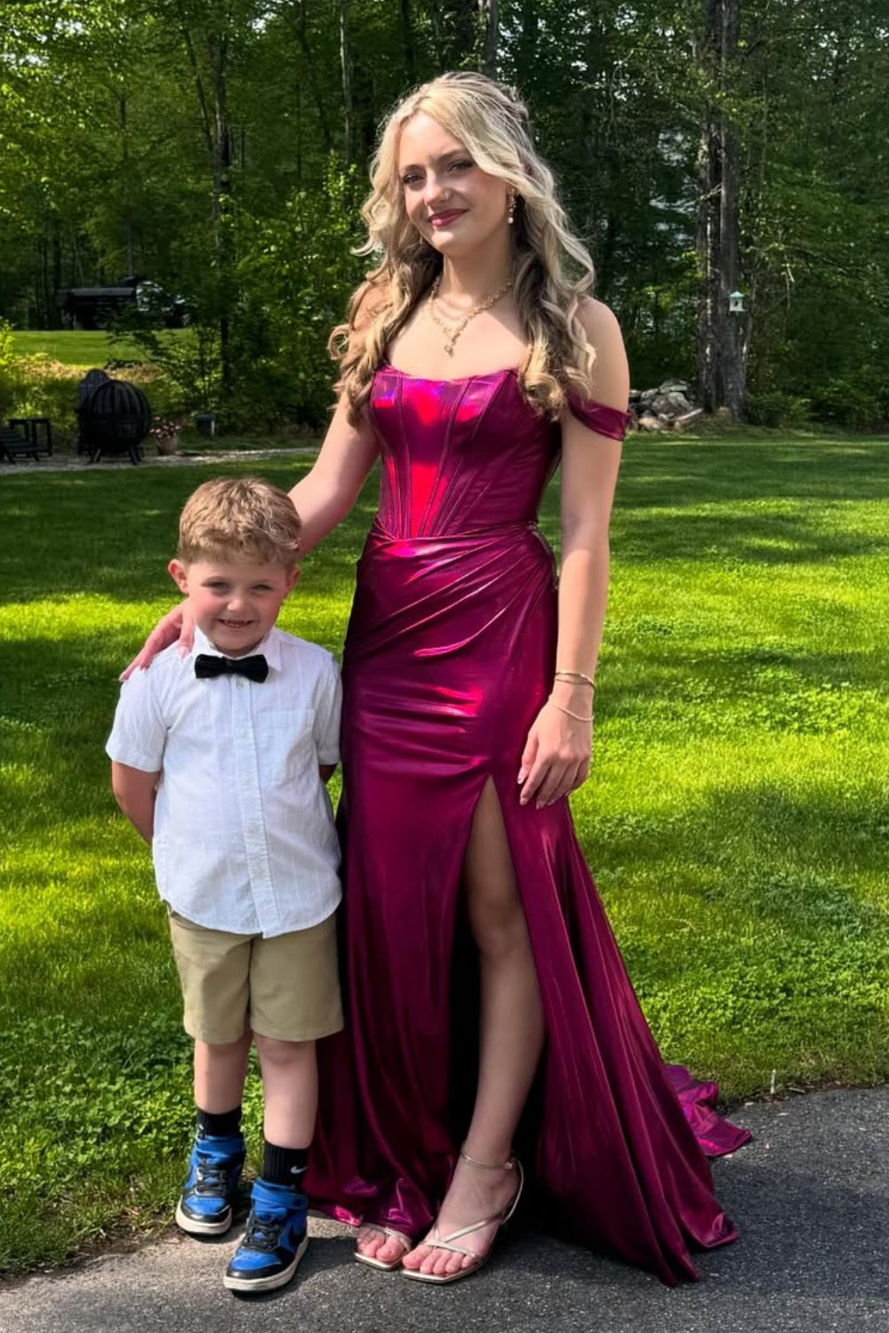 Metallic fuchsia off-the-shoulder mermaid prom dress with a structured corset bodice and high leg slit.