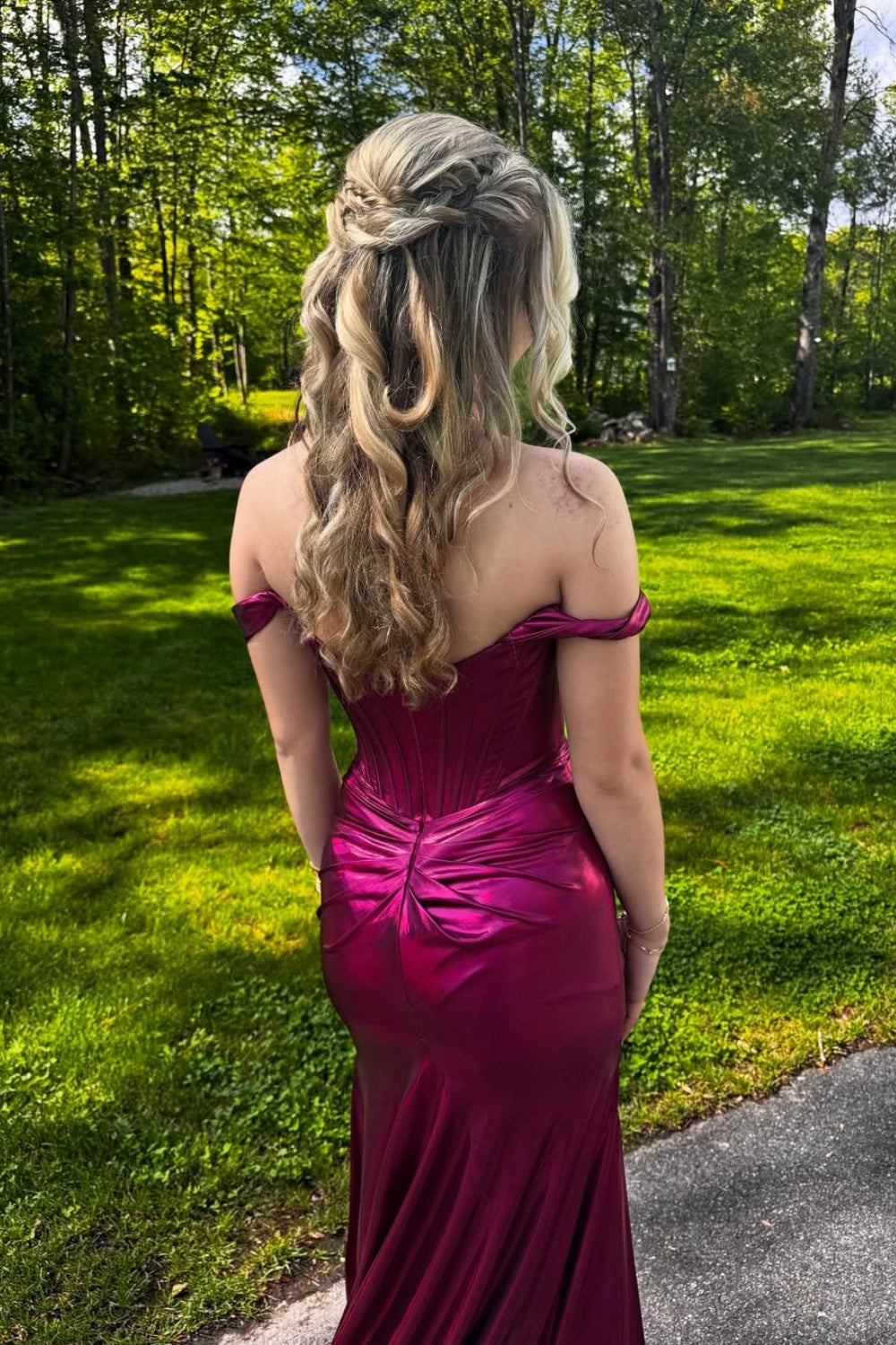 Metallic fuchsia off-the-shoulder mermaid prom dress with a structured corset bodice and high leg slit.