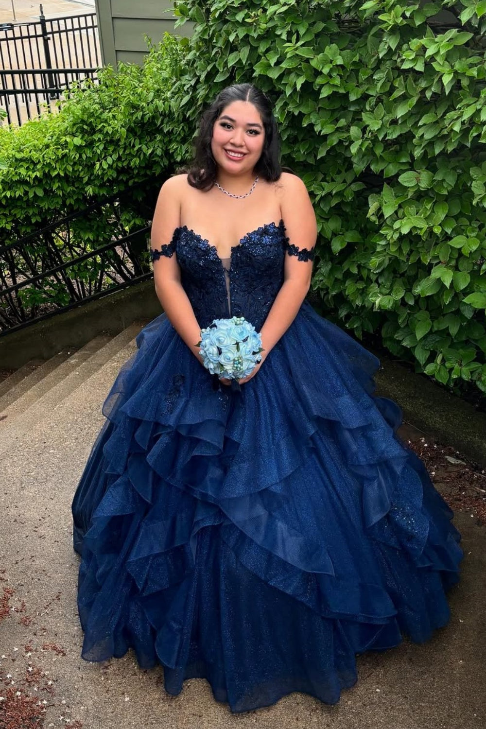 Navy blue off-the-shoulder A-line prom dress featuring delicate lace appliques and a voluminous tulle skirt.