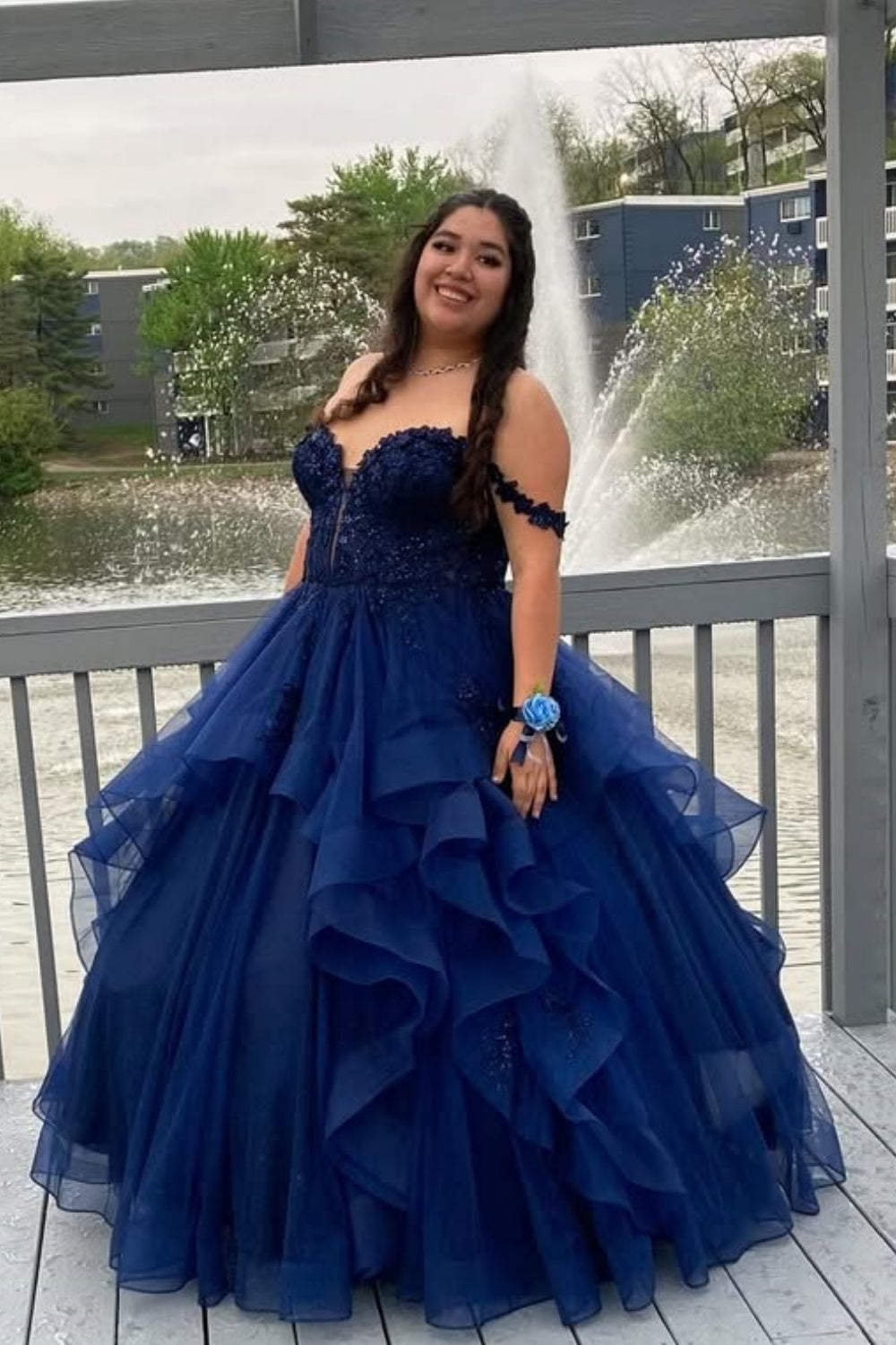 Navy blue off-the-shoulder A-line prom dress featuring delicate lace appliques and a voluminous tulle skirt.