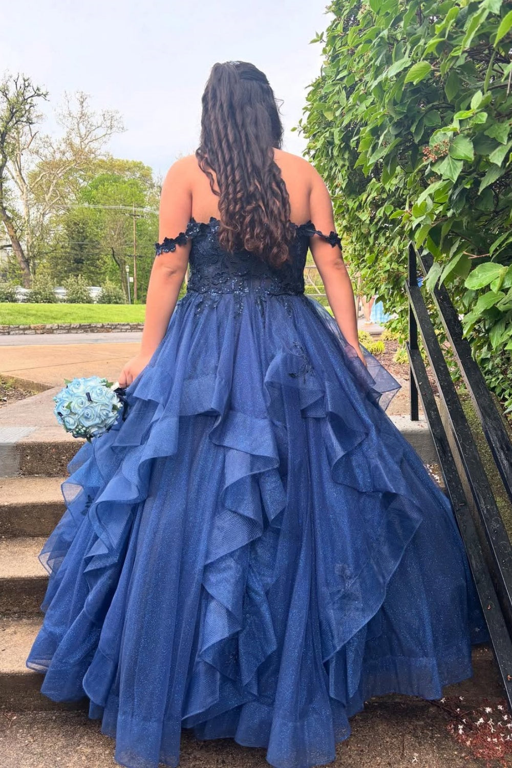 Navy blue off-the-shoulder A-line prom dress featuring delicate lace appliques and a voluminous tulle skirt.