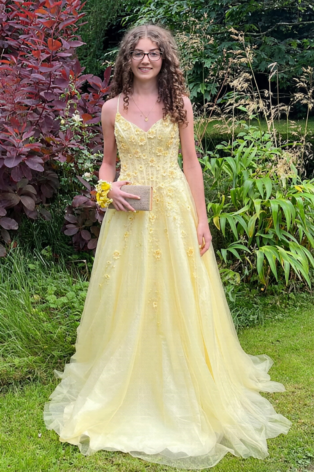 Yellow A-line tulle prom dress featuring vibrant 3D-flower appliques and delicate spaghetti straps.