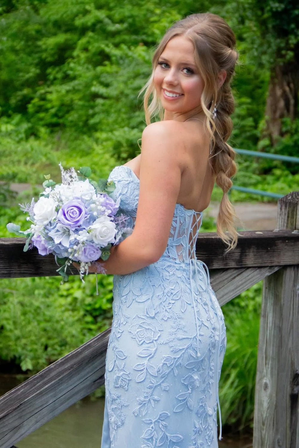 Light blue sweetheart mermaid prom dress featuring intricate beaded lace appliques and a high side leg slit.
