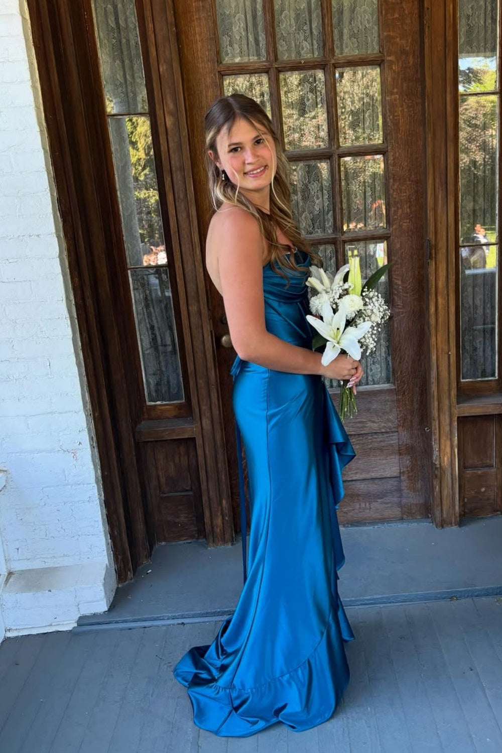 Royal blue A-line prom dress featuring a sophisticated cowl neckline, high side slit, and a dramatic ruffled hemline.