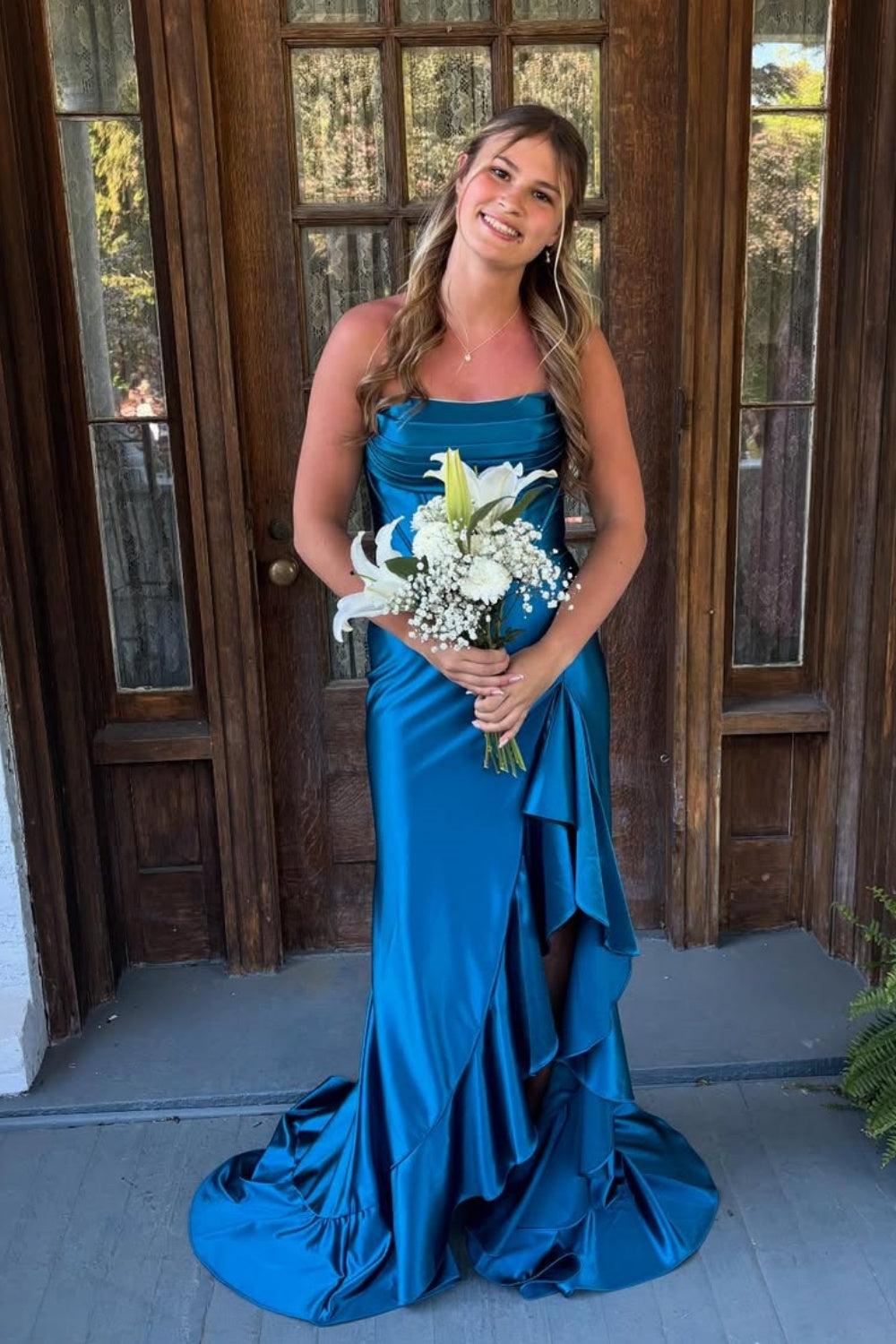 Royal blue A-line prom dress featuring a sophisticated cowl neckline, high side slit, and a dramatic ruffled hemline.