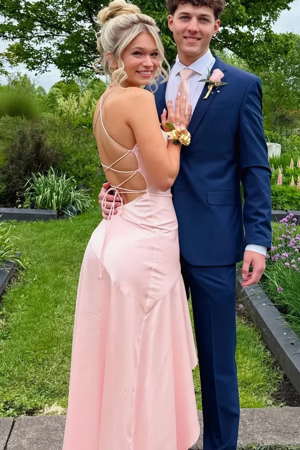 Pink A-line prom dress featuring dainty spaghetti straps and a modern irregular asymmetric hemline.