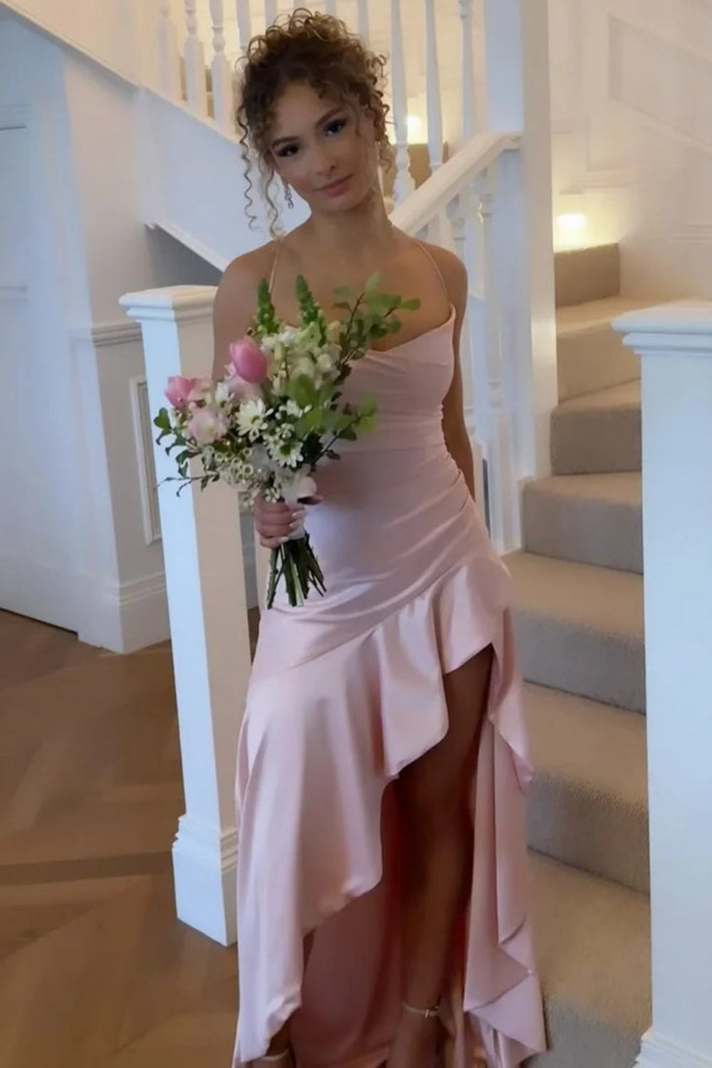 Pink A-line prom dress featuring dainty spaghetti straps and a modern irregular asymmetric hemline.