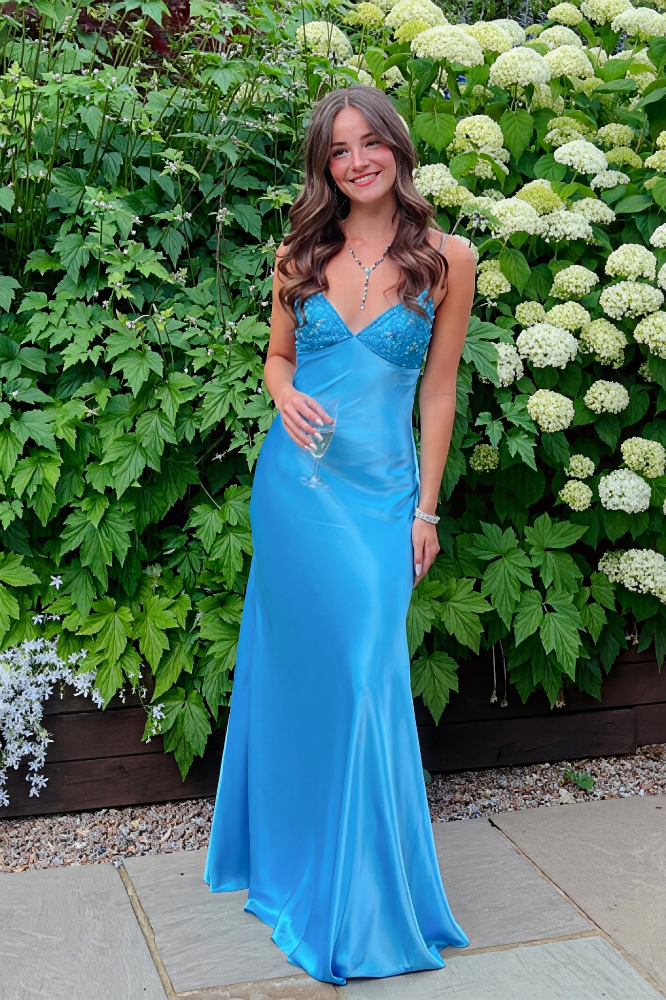 Blue mermaid satin prom dress featuring shimmering beaded spaghetti straps and a sleek, fitted silhouette.