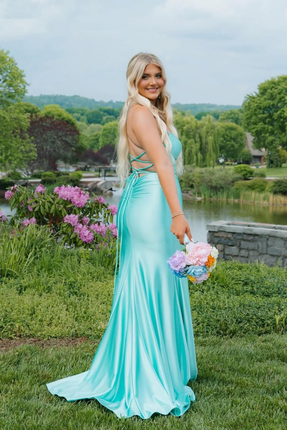 Plus size mint green mermaid prom dress featuring delicate spaghetti straps, a flattering contoured fit, and a bold side leg slit.