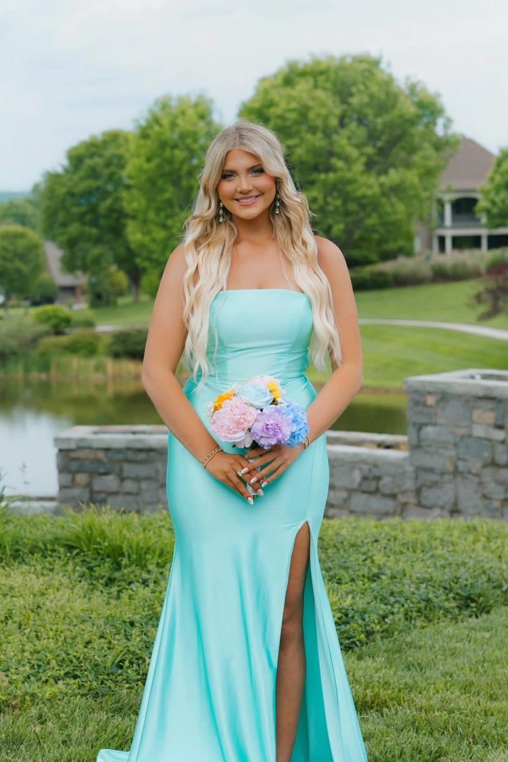 Plus size mint green mermaid prom dress featuring delicate spaghetti straps, a flattering contoured fit, and a bold side leg slit.
