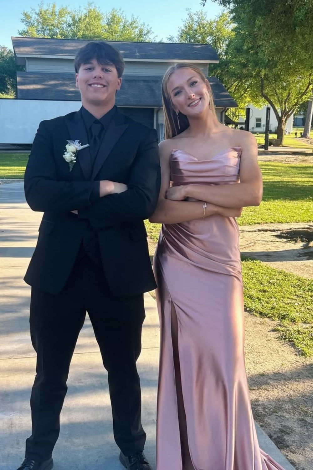 Blush pink long prom dress featuring a strapless neckline, a sophisticated ruched fitted bodice, and a sleek floor-length silhouette.