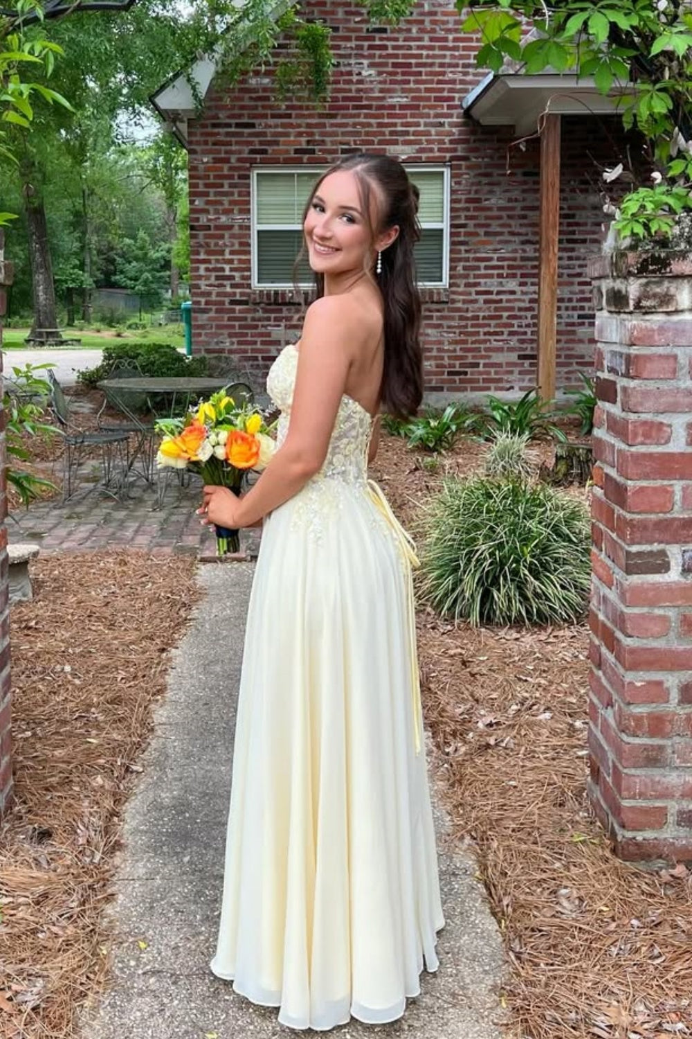 Yellow A-line formal dress featuring sweetheart neckline and lace appliques.