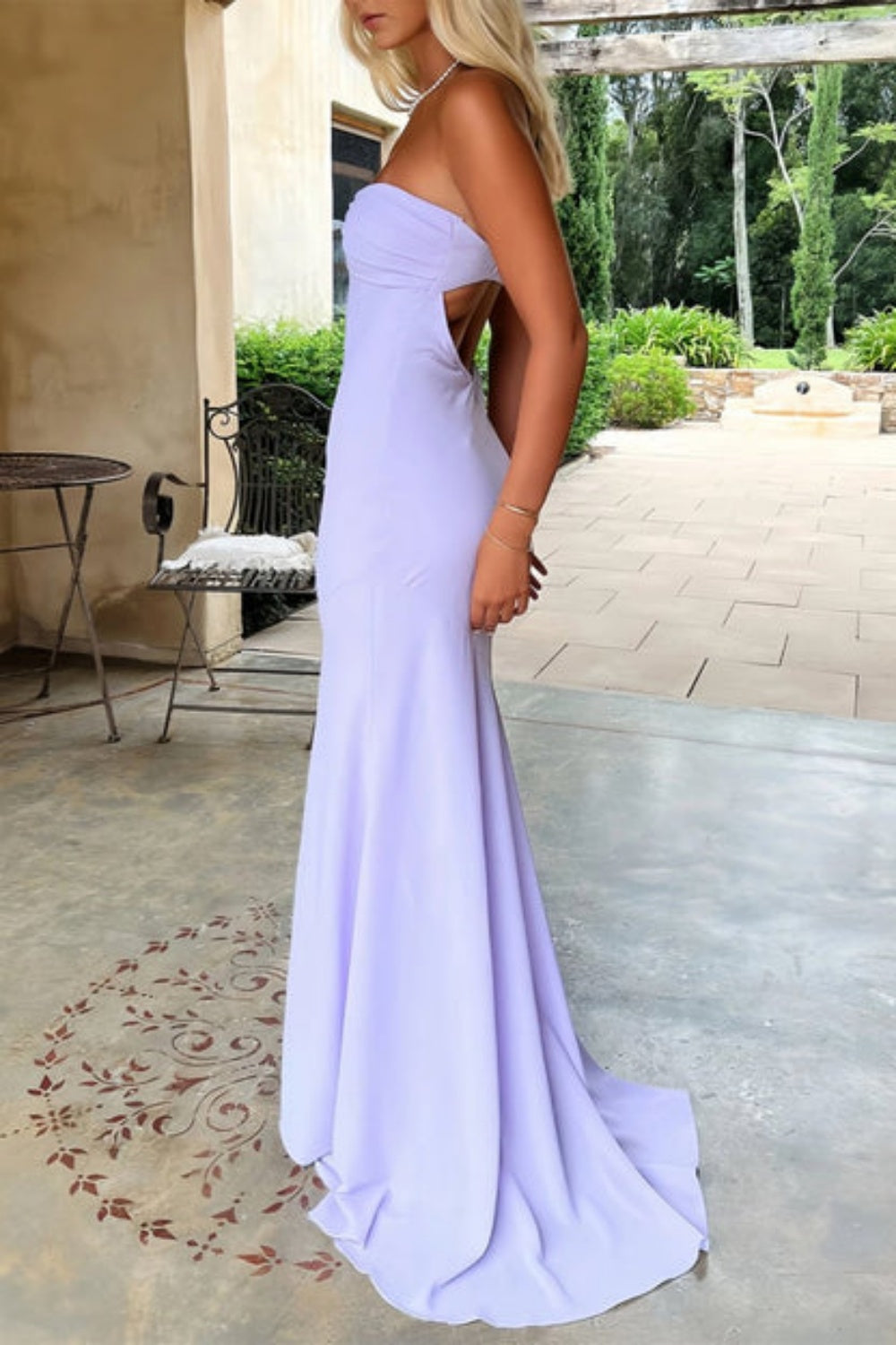 Lavender mermaid prom dress with a strapless neckline, ruched bodice, and adjustable lace-up back.