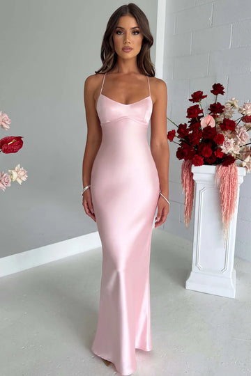 Fitted long pink formal prom dress with delicate spaghetti straps and a criss-cross lace-up back.